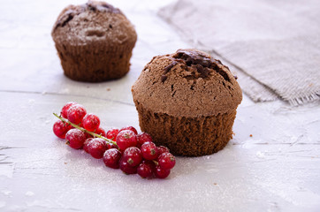 chocolate cupcake with cream, powdered sugar and berries