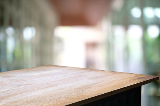 empty wood table over blurred outdoor cafe background