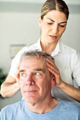 A Modern rehabilitation physiotherapy worker with senior client