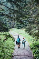 Obraz premium Family spending vacation on wandering with backpacks