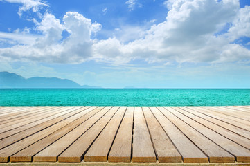 wooden table top sea view and blue sky