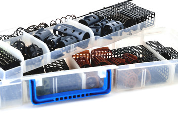 Feeder troughs of different colors and sizes in a plastic box for accessory close-up