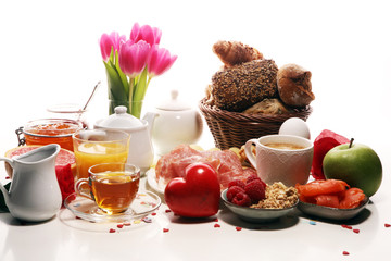 breakfast on table with bread buns, croissants, coffe and juice on carnival