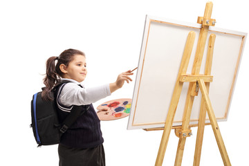 Schoolgirl painting on a canvas