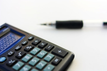 Calculator and pen on the table