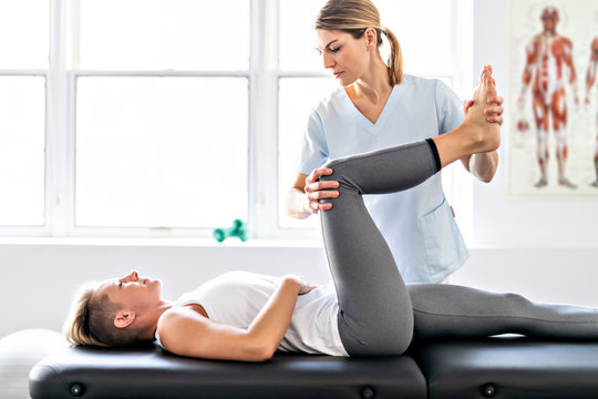 A Modern rehabilitation physiotherapy worker with woman client