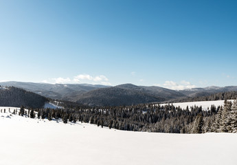 Fototapeta na wymiar White winter landscape mountains in the distance 