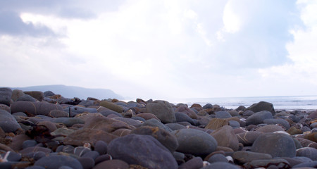 Pebbles on the beach looking towards the ocean
