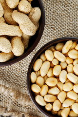 Peanuts in the shell and peeled closeup in a cup