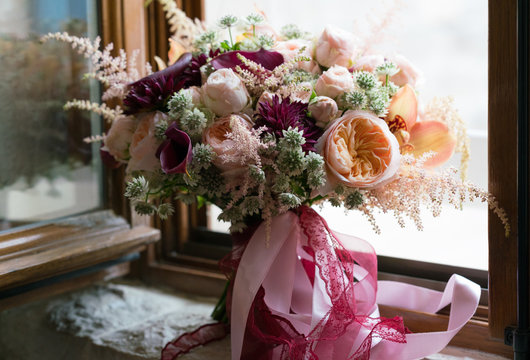 Peach Dark Red Wedding Bouquet Stands On The Windowsill