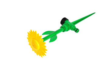 water spray for lawn irrigation yellow-green in the shape of a flower close-up white background