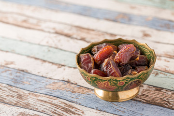 Plate of date on turquoise table side view