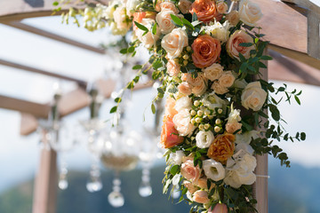 Obraz na płótnie Canvas Beautiful wooden wedding arch decorated with flowers
