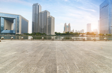 empty tiled floor and urban skyline,tianjin china
