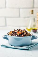 Beef and bean stew in a pot. Selective focus, space for text.