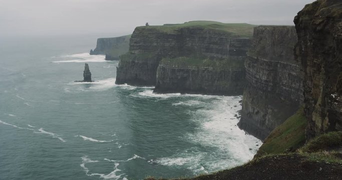 Amazing landscape capturing video of Cliffs of Moher on the shore of rocks with ocean view.
