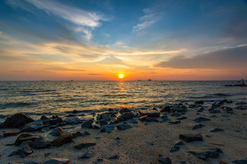 Obraz premium Red sky over a rocky seashore. Sunset landscape.