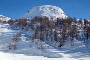 Panoramic view of the sunny snow-covered landscape of the Alpe Sangiatto above the Alpe Devero in Piedmont, Italy.