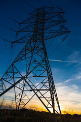 Electricity pylon seen from below at sunset