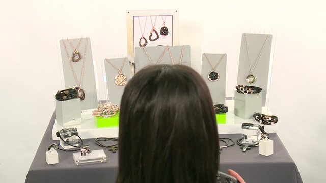 A photographer takes pictures of jewelry and models in the pavilion