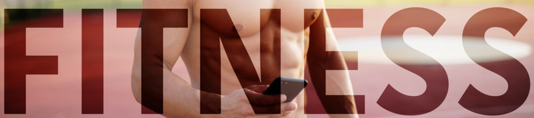 Close up of shirtless muscular man using smart phone outdoors on sunny morning. Upper-case fitness over the picture.