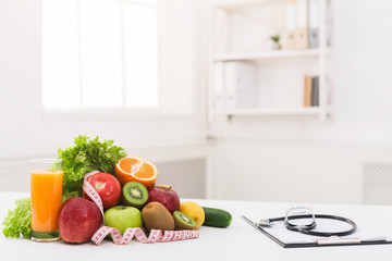 Nutritionist desk with healthy fruit and stethoscope