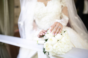 bridal hands on a wedding bouquet