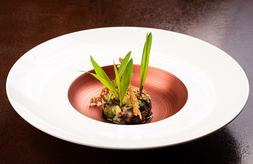 Vegan Fine dining appetizer in a gourmet restaurant, vegetable and beans with sauce