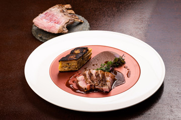 Veal cutlets with black pudding, potato cake with leek
