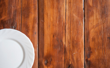 Blank white dish on a wood background.