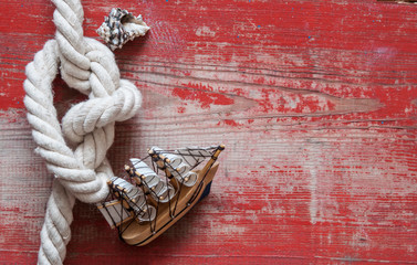 Fototapeta na wymiar Ship rope and sea shell on wood background