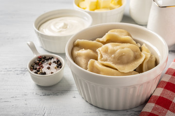 Traditional pelmeni, ravioli, dumplings with meat, close-up.