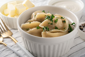 Traditional pelmeni, ravioli, dumplings with meat, close-up.