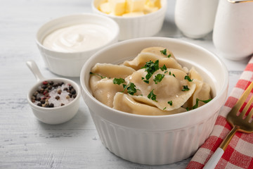 Traditional pelmeni, ravioli, dumplings with meat, close-up.