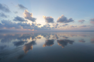 Seascape with clouds reflections on beach