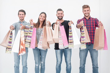 young people showing their colorful shopping bags