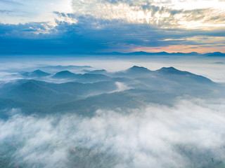 Obraz premium Aerial view of mountain and morning mist during sunrise.