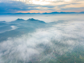 Aerial view of mountain and morning mist during sunrise.