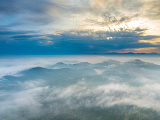 Fototapeta premium Aerial view of mountain and morning mist during sunrise.