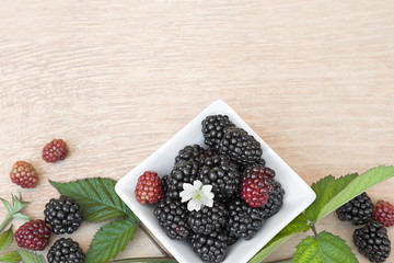 Closeup shot of fresh blackberries fruit (rubus fruticosus) a wooden table.Top view. 