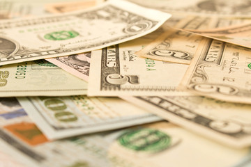 Abstract background of various dollar bills. Selective focus.