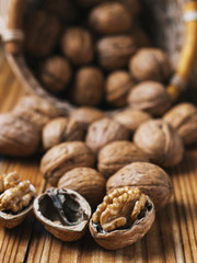Walnut on a wooden table in a wicker basket