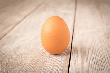 Chicken egg on a wooden table. Close up.