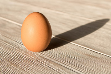 Chicken egg on a wooden table. Close up.