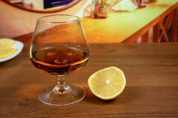 Cognac (brandy) in snifter glass with lemon