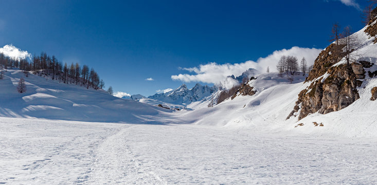 Panoramic view of the sunny snow-covered landscape of the Alpe Sangiatto above the Alpe Devero in Piedmont, Italy.