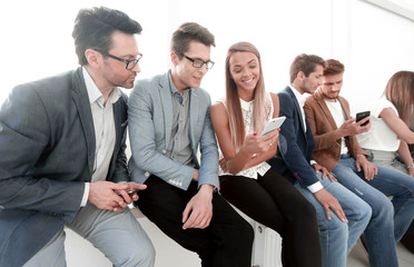 group of young people use their smartphones