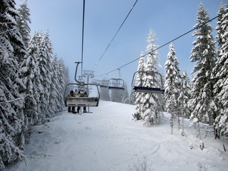 Ski chairlift between the snowy trees