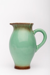 Old green milk jug  on the white background