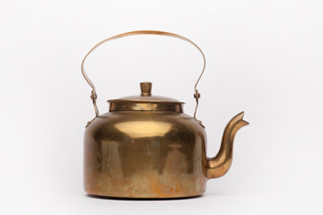 Old brass teapot on the white background